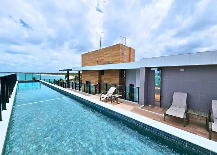 Flat pé na areia e vista mar
